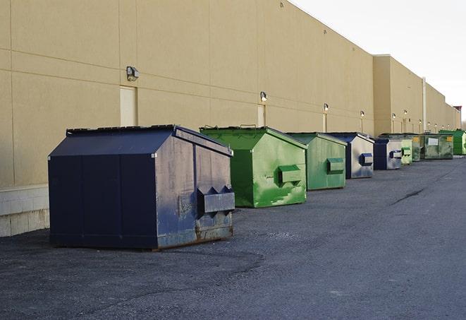 a fleet of red and blue construction dumpsters available for use in Altamont, NY